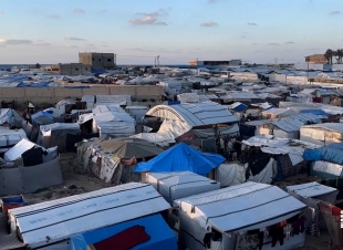 الغزيون يقومون بإعداد مخيمات للعائلات التي ستعود إلى الشمال بعد سريان وقف إطلاق النار